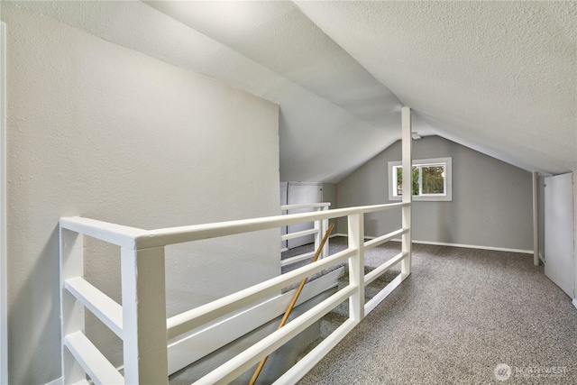 bonus room featuring carpet flooring, vaulted ceiling, and a textured ceiling