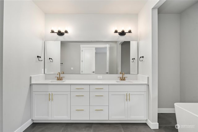 bathroom featuring tile patterned flooring, a washtub, and vanity