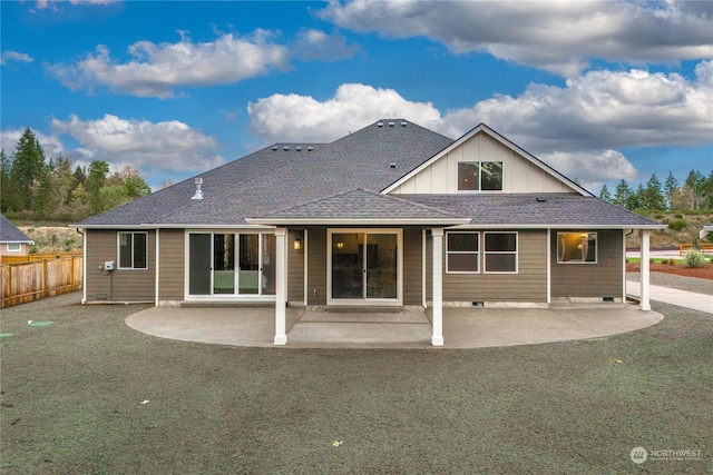 back of house with a patio area and a yard