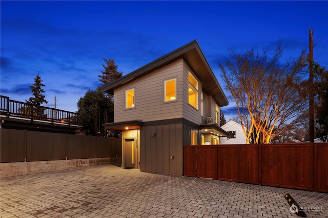 property exterior at dusk featuring a patio