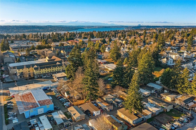 birds eye view of property with a water and mountain view