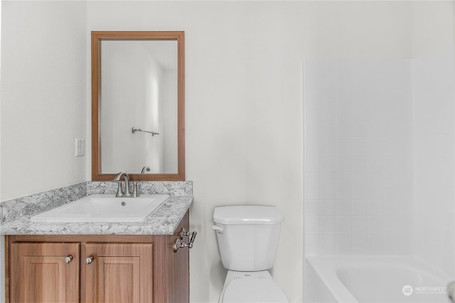 bathroom with vanity, toilet, and a bathing tub