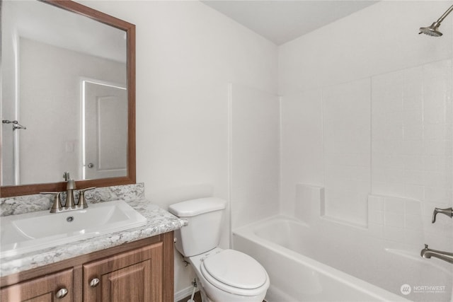 full bathroom featuring bathtub / shower combination, vanity, and toilet