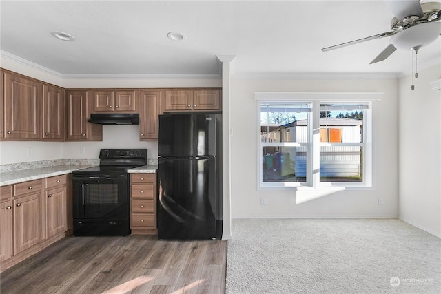 kitchen featuring ceiling fan, ornamental molding, dark hardwood / wood-style flooring, and black appliances