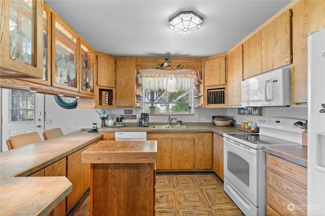 kitchen with sink, a wealth of natural light, and white appliances