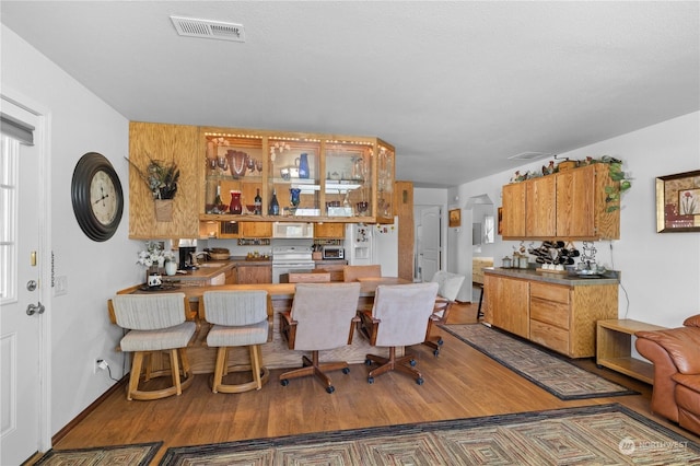 kitchen with sink, hardwood / wood-style floors, and white appliances