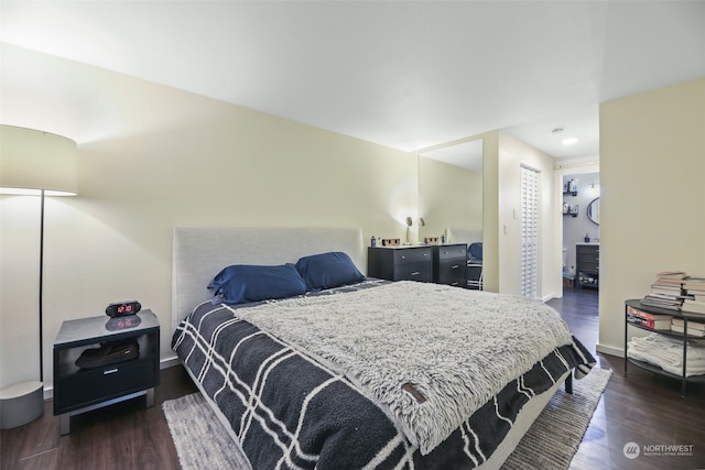 bedroom with dark wood-type flooring