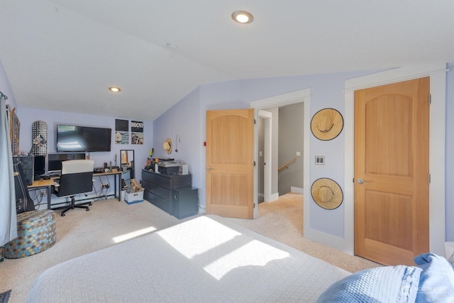 bedroom with vaulted ceiling and light colored carpet