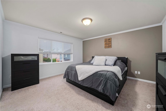 bedroom featuring ornamental molding and carpet