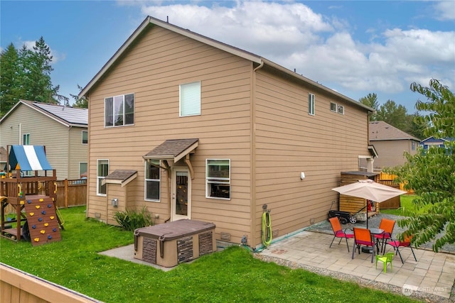 rear view of house featuring a yard, a playground, and a patio area