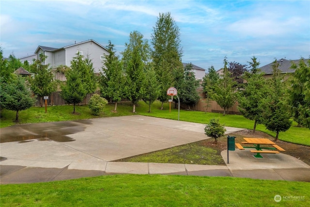 view of basketball court with a yard