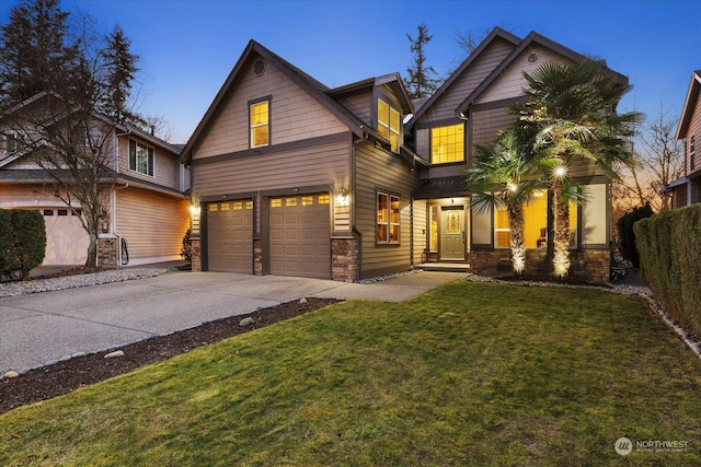 view of front of property featuring a garage and a lawn