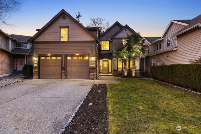 view of front of home featuring a garage and a yard