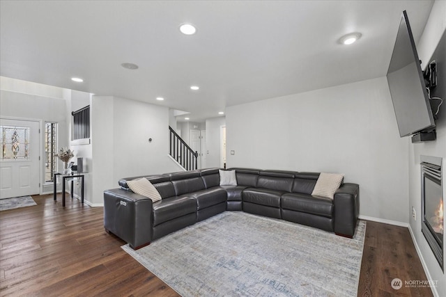 living room with dark hardwood / wood-style flooring