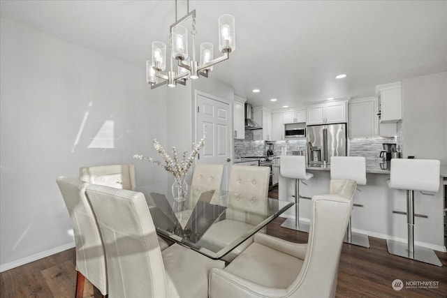 dining room with a notable chandelier and dark hardwood / wood-style floors