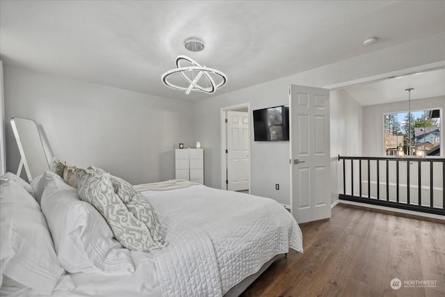 bedroom with dark hardwood / wood-style flooring and a notable chandelier