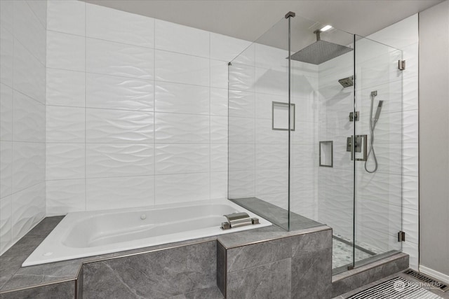 bathroom featuring shower with separate bathtub