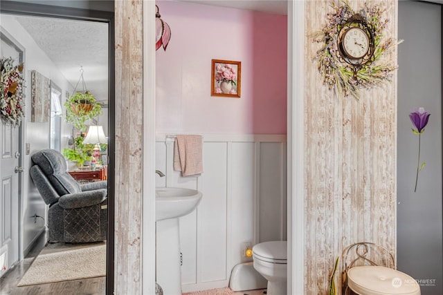 bathroom featuring a textured ceiling and toilet