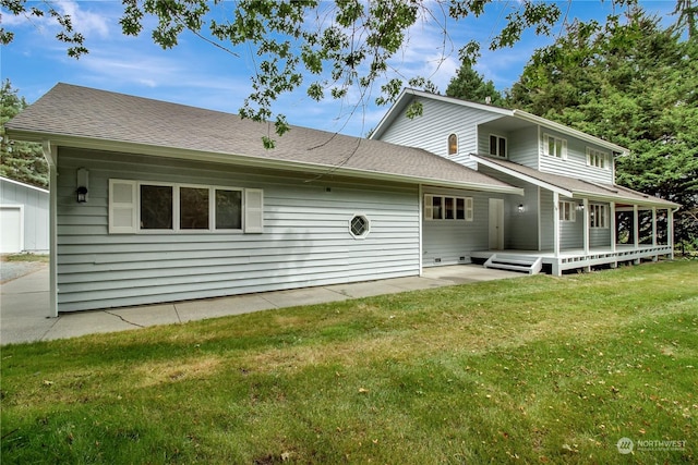 back of property featuring a deck and a yard