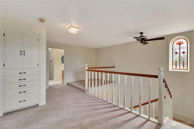 corridor with light colored carpet