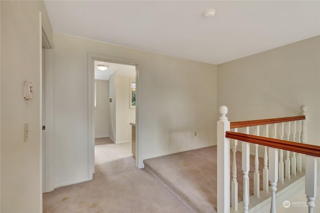 hallway with light colored carpet