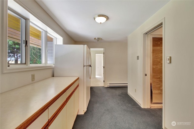 hall featuring a baseboard heating unit and dark colored carpet