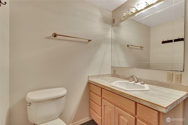 bathroom with toilet and vanity