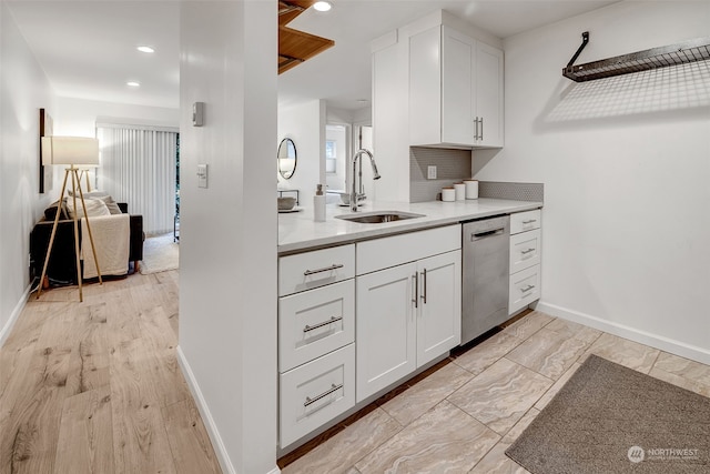 kitchen featuring white cabinetry, sink, tasteful backsplash, and stainless steel dishwasher