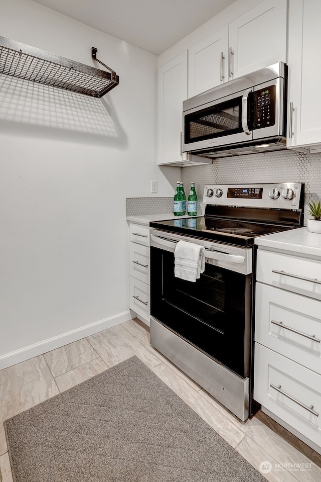 kitchen featuring white cabinetry and appliances with stainless steel finishes