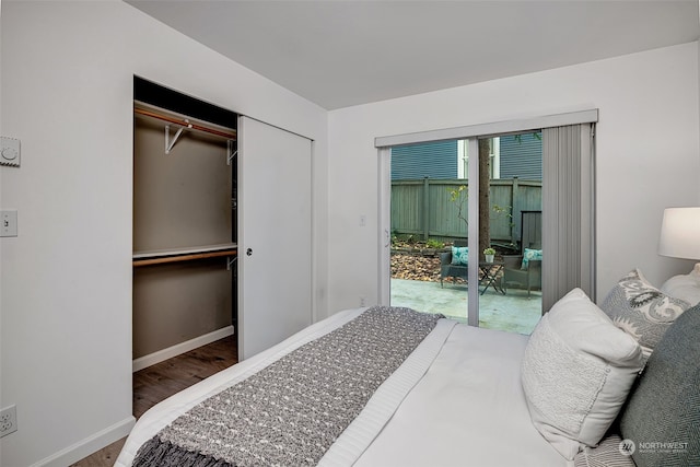 bedroom featuring access to exterior, hardwood / wood-style flooring, and a closet