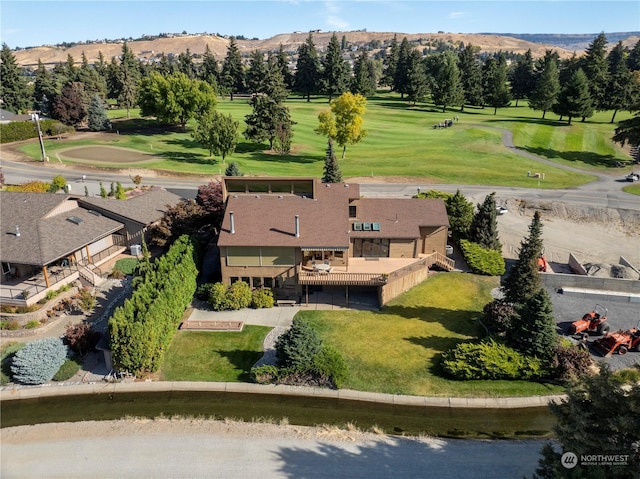 bird's eye view with view of golf course and a mountain view