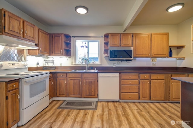 kitchen featuring sink, white appliances, and light hardwood / wood-style flooring