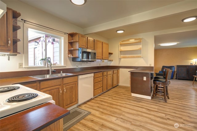 kitchen with beam ceiling, dishwasher, sink, and light hardwood / wood-style flooring