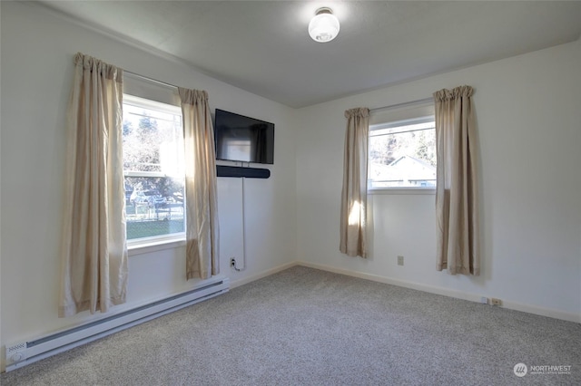 spare room featuring carpet and a baseboard radiator