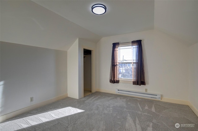 additional living space with carpet, baseboard heating, and vaulted ceiling