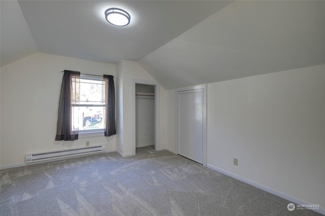 bonus room with carpet floors, baseboard heating, and vaulted ceiling