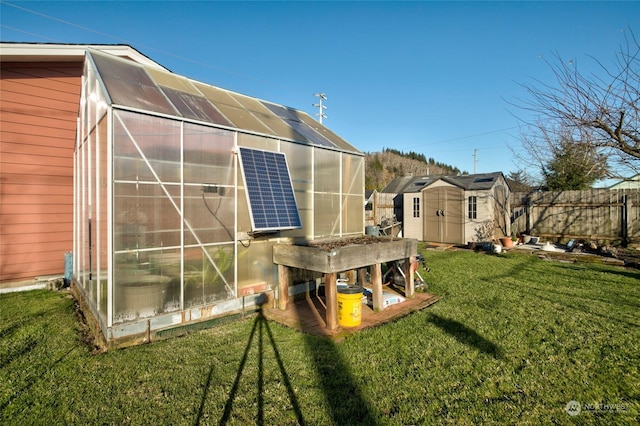 exterior space with a lawn and a storage unit