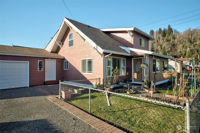 view of front facade with a garage and a front yard