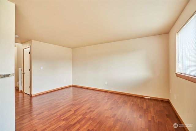 unfurnished room featuring hardwood / wood-style flooring