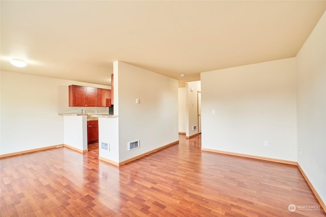 unfurnished room with light hardwood / wood-style floors