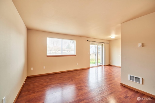 unfurnished room with hardwood / wood-style flooring