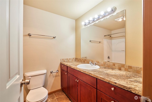 bathroom with decorative backsplash, toilet, vanity, and tile patterned flooring