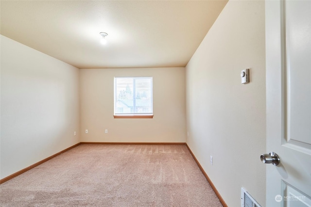 empty room featuring light carpet