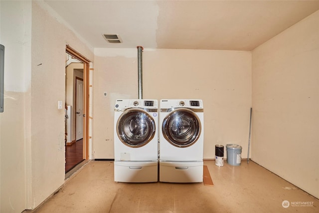 washroom with washing machine and clothes dryer