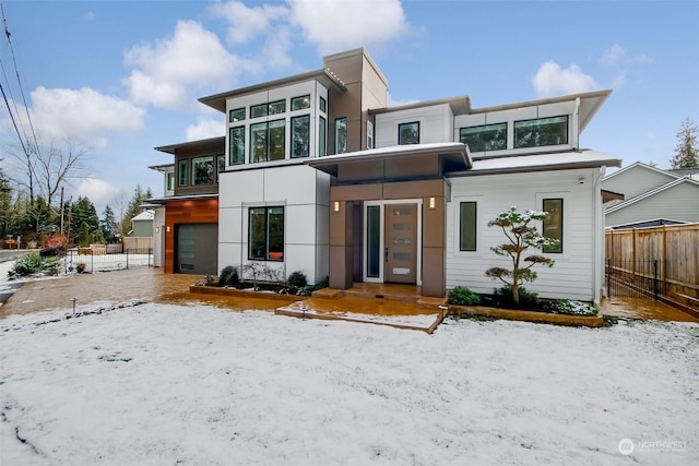 snow covered house with a garage