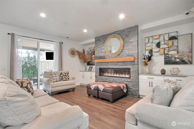 living room with hardwood / wood-style floors and a fireplace