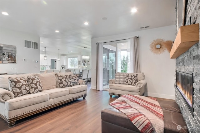 living room with hardwood / wood-style flooring and a fireplace