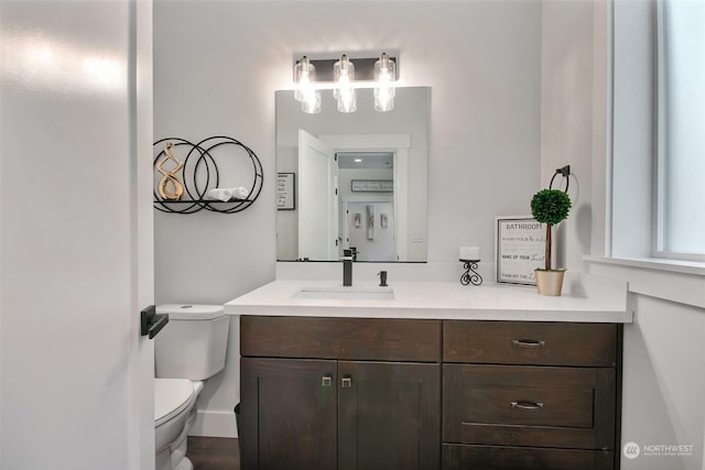 bathroom featuring vanity and toilet