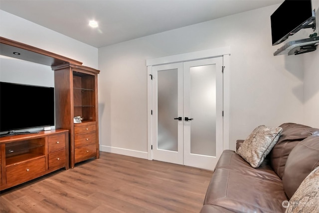 living room with french doors and hardwood / wood-style floors