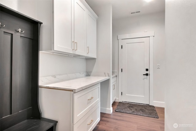 clothes washing area with hardwood / wood-style flooring